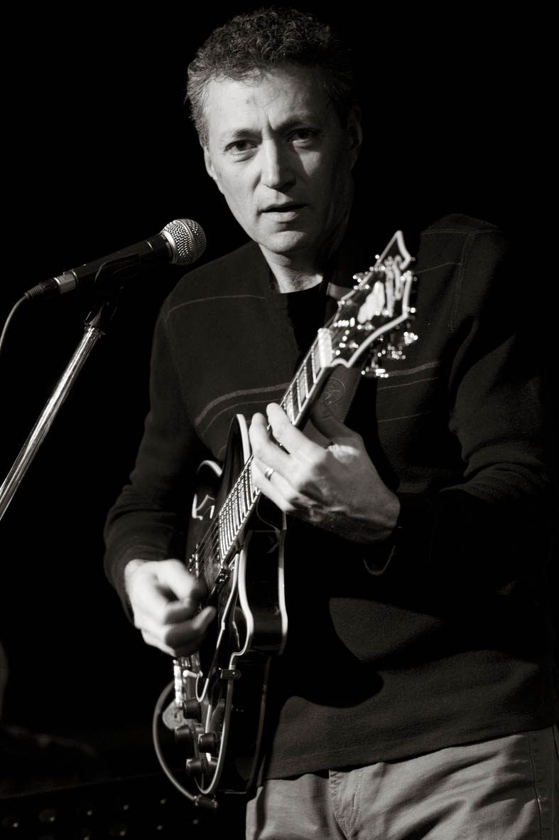 Black and white portrait of New Jersey jazz guitarist Vinny Valentino at the microphone