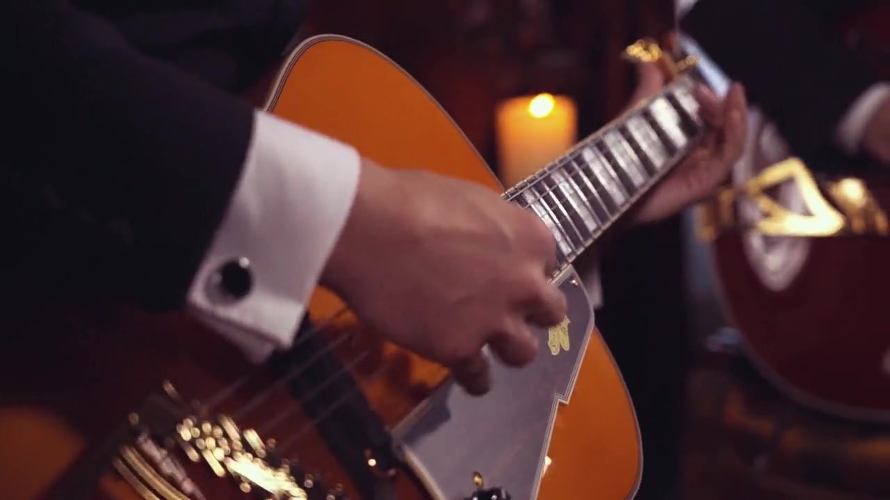 Close-up of Vinny Valentino's hands on an archtop jazz guitar
