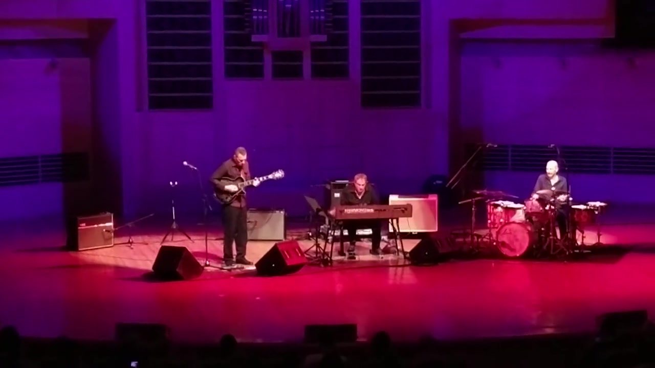 Vinny Valentino and his band on a concert hall stage