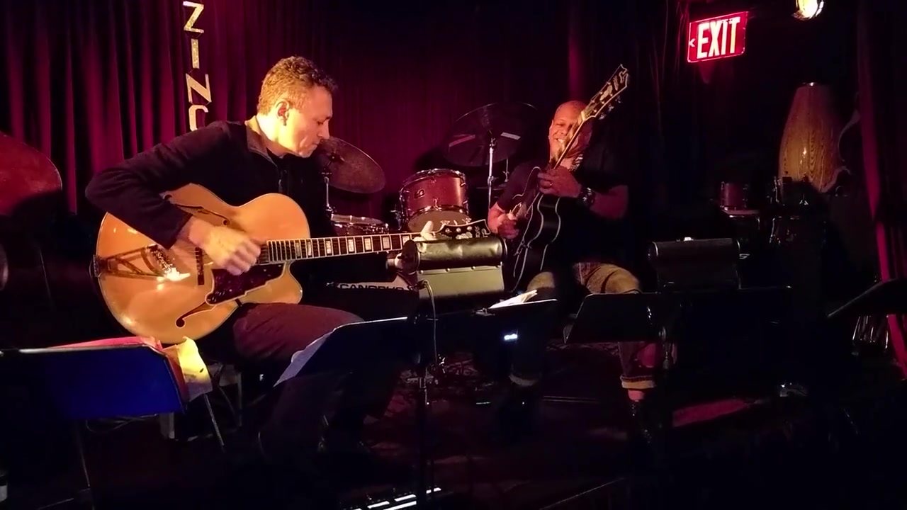 Vinny Valentino performing with a jazz trio in a New York club